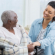 A smiling Family Caregiver looking at their aging parent.